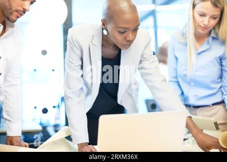 Colleagues using laptop Stock Photo