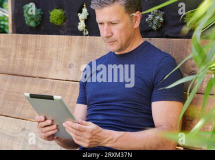 Mature man using digital tablet Stock Photo