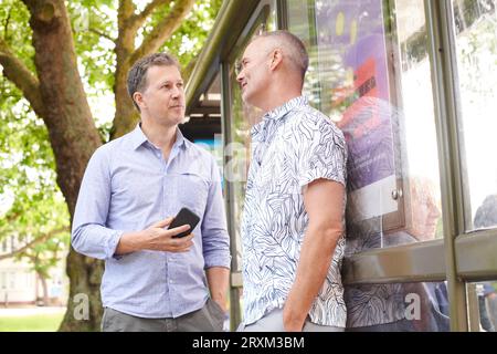 Mature couple by bus shelter Stock Photo
