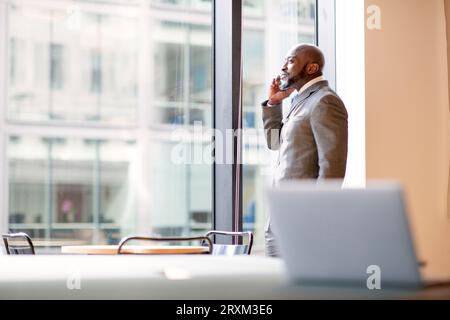 Businessman on phone in office Stock Photo