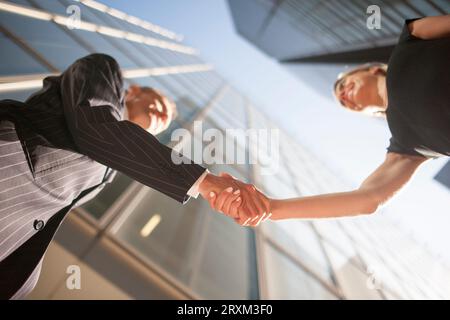 Low angle view of businesspeople shaking hands Stock Photo
