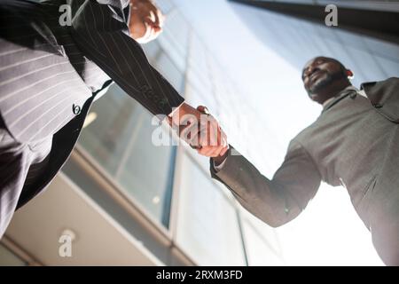 Low angle view of businessmen shaking hands Stock Photo