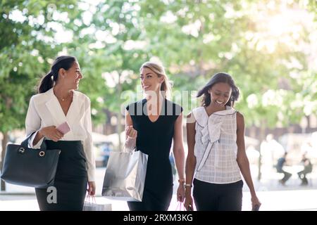Businesswomen walking on sidewalk Stock Photo