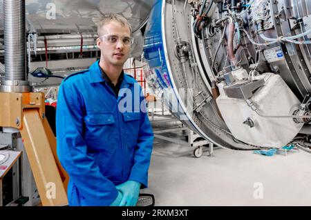 Portrait of young male worker in airplane hangar Stock Photo
