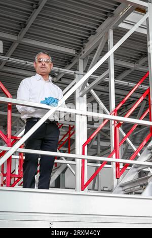 Man wearing safety equipment on staircase Stock Photo