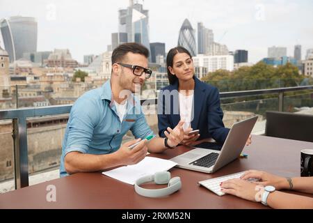 Businesspeople during meeting on balcony Stock Photo