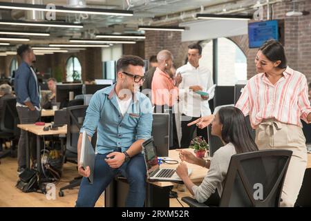 Colleagues talking in office Stock Photo