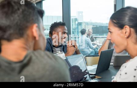 Colleagues using laptops during meeting Stock Photo