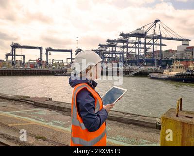 Dock worker with digital tablet at Port of Felixstowe, England Stock Photo