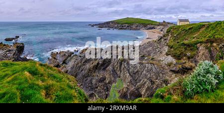Rocky coastline with Little Fistral Beach in background, Newquay, England, UK Stock Photo