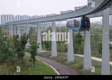 (230926) -- WUHAN, Sept. 26, 2023 (Xinhua) -- This aerial photo taken on Sept. 26, 2023 shows a new suspended monorail line in operation in Wuhan, central China's Hubei Province. China's first commercial suspended monorail line opened to the public on Tuesday in Wuhan, capital of central China's Hubei Province.   The suspended monorail line operates for 12 hours every day, with a monorail departing every 10 minutes.    The maximum operating speed of the monorail train is 60 km per hour. The entire operation process, including starting, entering stations, opening and closing doors, is fully aut Stock Photo