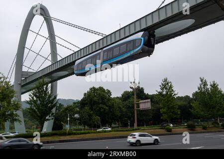 (230926) -- WUHAN, Sept. 26, 2023 (Xinhua) -- This aerial photo taken on Sept. 26, 2023 shows a new suspended monorail line in operation in Wuhan, central China's Hubei Province. China's first commercial suspended monorail line opened to the public on Tuesday in Wuhan, capital of central China's Hubei Province. The suspended monorail line operates for 12 hours every day, with a monorail departing every 10 minutes. The maximum operating speed of the monorail train is 60 km per hour. The entire operation process, including starting, entering stations, opening and closing doors, is fully aut Stock Photo