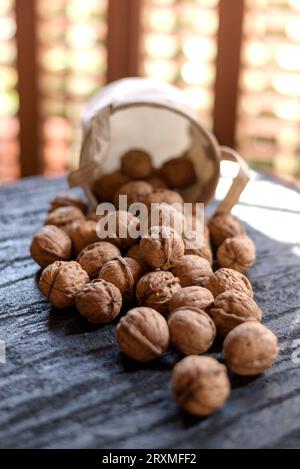 Walnuts in a burlap sack. Selective focus Stock Photo