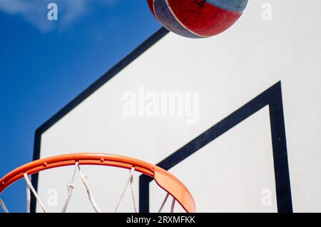 close-up view of a basketball basket and ball against a backboard Stock Photo