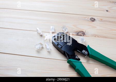 Crimping tool with a network connectors on wooden table Stock Photo