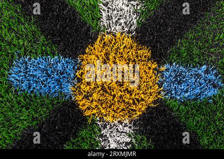 Center mark on a synthetic turf football, lacrosse, soccer field. Stock Photo