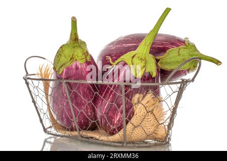 Three organic ripe eggplants in a basket, macro, isolated on white background. Stock Photo