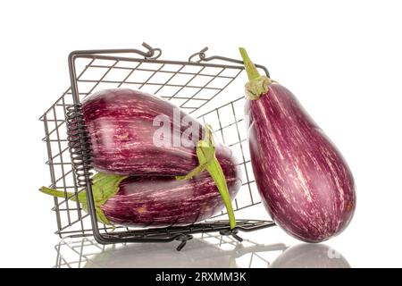 Three organic ripe eggplants in a basket, macro, isolated on white background. Stock Photo