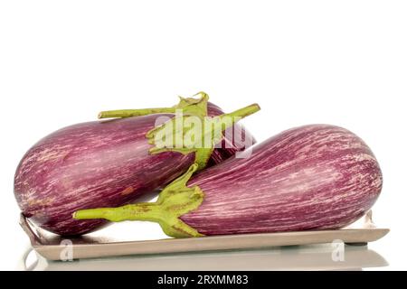 Three organic ripe eggplants with metal tray, macro, isolated on white background. Stock Photo
