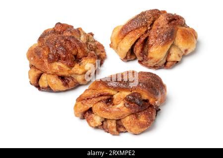 Three fresh homemade cinnamon rolls close up isolated on white background Stock Photo