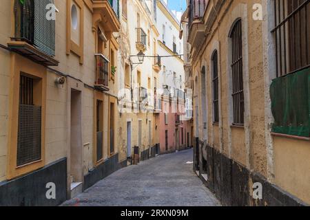 CADIZ, SPAIN - MAY 22, 2017: This is an narrow old street in the residential Populo District. Stock Photo