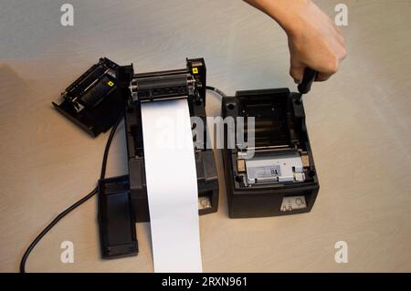 Top view. Technician repairing printer, thermal printer. Stock Photo