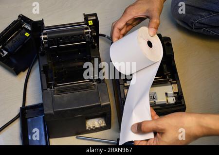 Top view. Technician repairing printer, thermal printer. Stock Photo
