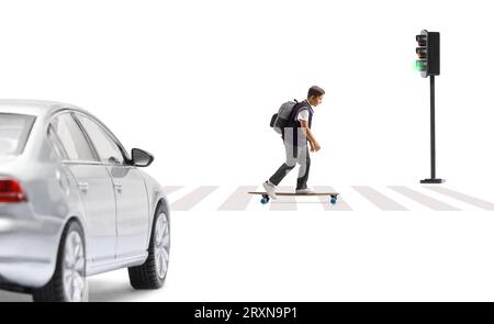 Full length profile shot of a schoolboy riding a skateboard at a pedestrian crossing isolated on white background Stock Photo