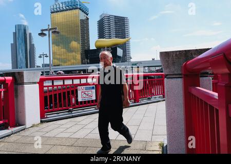 An elderly Japanese man walks across a bridge in Asakusa, Tokyo, Japan Stock Photo