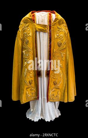 Chasuble, outermost liturgical vestment worn by clergy for celebration of the Eucharist in Western-tradition Christian churches on black background Stock Photo