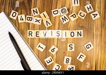 Revision flat lay scattered letters with notebook and pen Stock Photo