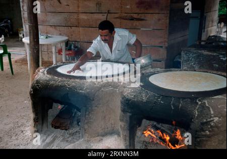 Man baking yucca bread, pan casabe, Gran Sabana, Bolivar province, Venezuela, casabe bread Stock Photo