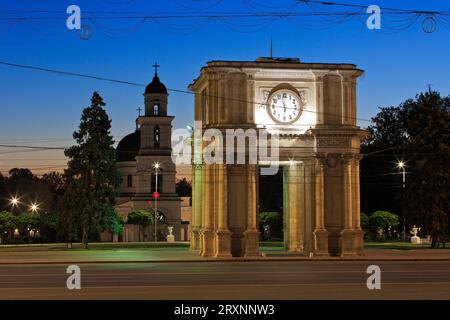 The Triumphal Arch (1841) and Nativity Cathedral (1836) with bell tower at the Great National Assembly Square in Chisinau, Moldova Stock Photo