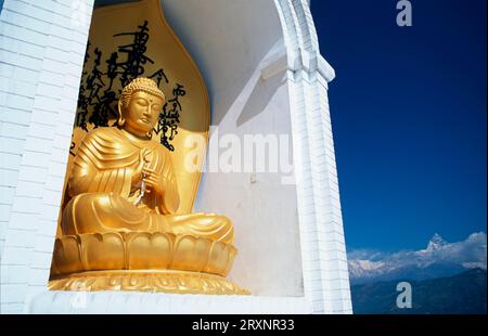 Statue of a seated Buddha in the World Peace Pagoda, Pokhara, Nepal Stock Photo