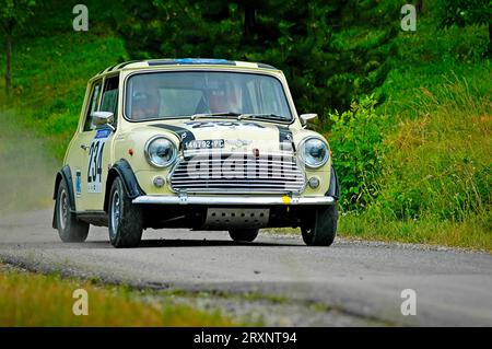 Italy - September 7, 2005 - Unidentified drivers on a yellow vintage Mini Cooper racing car Stock Photo