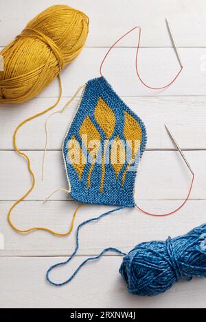 The process of knitting a hat with circular knitting needles using the short rows method Stock Photo