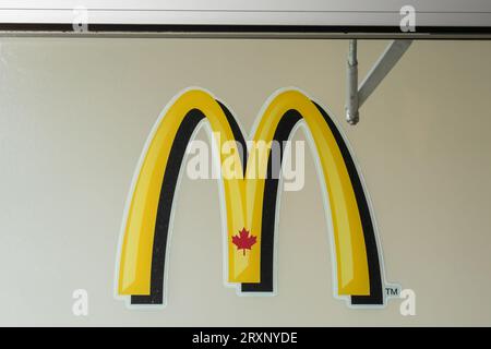 Mcdonalds Golden Arches With Red Maple Leaf Symbol On Drive-thru Sign 