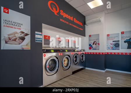 Fossano, Italy - September 26, 2023: Washing machines in Speed Queen chain self-service laundry, number one commercial laundry in the world Stock Photo