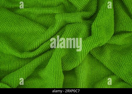A green microfiber cleaning towel texture background. Close up. Stock Photo