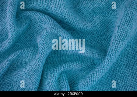 A blue microfiber cleaning towel texture background. Close up. Stock Photo