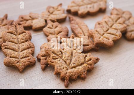 Autumn leaf shaped cookie of gingerbread dough. Autumn festive cookies. Handmade bakery. Gingerbread cookies. Homemade thanksgiving dessert. Stock Photo