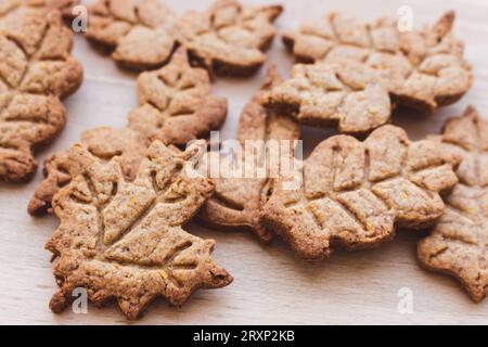 Autumn leaf shaped cookie of gingerbread dough. Autumn festive cookies. Handmade bakery. Gingerbread cookies. Homemade thanksgiving dessert. Stock Photo