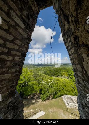 View through a corbel arch in El Castillo in the Xunantunich Archeological Reserve in Belize.   Guatemala is in the distance. Stock Photo