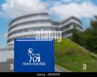 Corporate headquarters of Novo Nordisk. Selective focus on sign. Building blurred. A pharmaceutical company headquartered in Denmark. Copenhagen, Denm Stock Photo