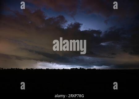Menacing stormy sky is illuminated by lightning Stock Photo