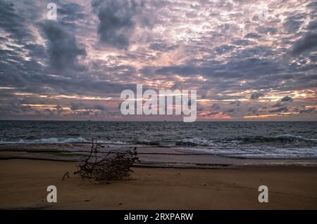sunset over the sea, big waves and cloudy sky Stock Photo