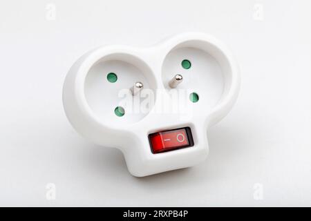 Double EU European electric socket extension plug with two socket outputs and earth pin, simple power outlet splitter with a switch, object closeup, i Stock Photo