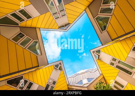 Rotterdam, the Netherlands - July 18, 2023: Yellow cube houses in Rotterdam designed by Piet Blom. Bottom view of abstract modern innovative architect Stock Photo