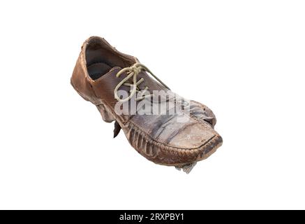 Old damaged shoe without sole left behind on the ground, object isolated on white background, cut out. Poverty, poor people symbol abstract concept, c Stock Photo