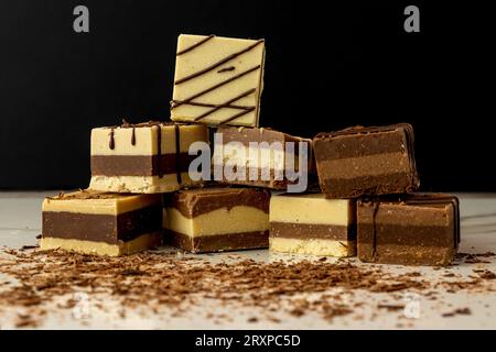 stacked moroccan or cremino style chocolate bars with grated chocolate on a dark background Stock Photo